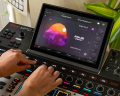 Music production setup with a tablet displaying audio software on a digital audio workstation.
