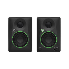 Pair of black studio monitors with green accents on a white background