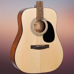 Acoustic guitar with a visible brand logo on a gradient background