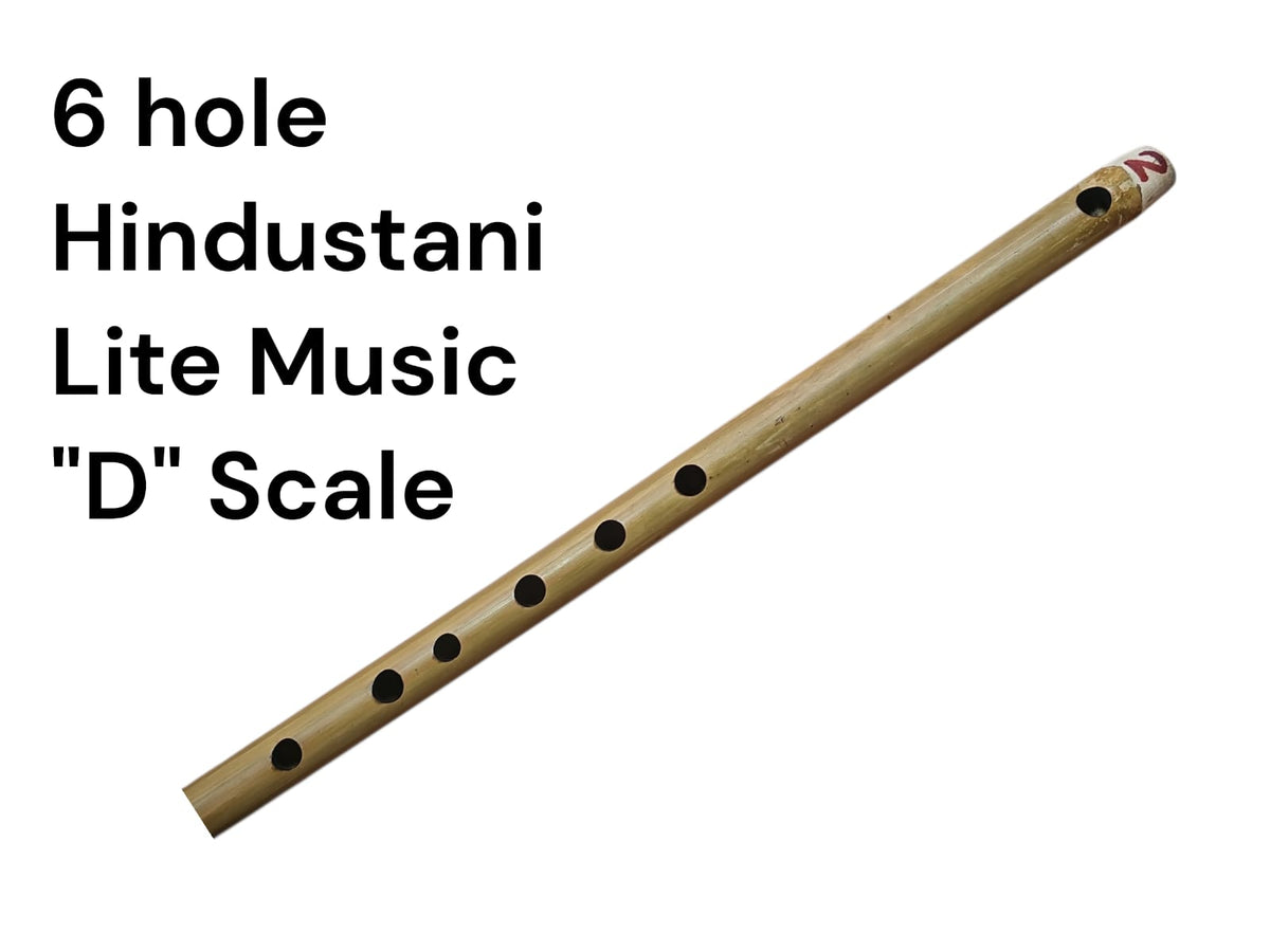 Bamboo flute with six holes on a white background, labeled as a 6 hole Hindustani Lite Music 'D' Scale flute.