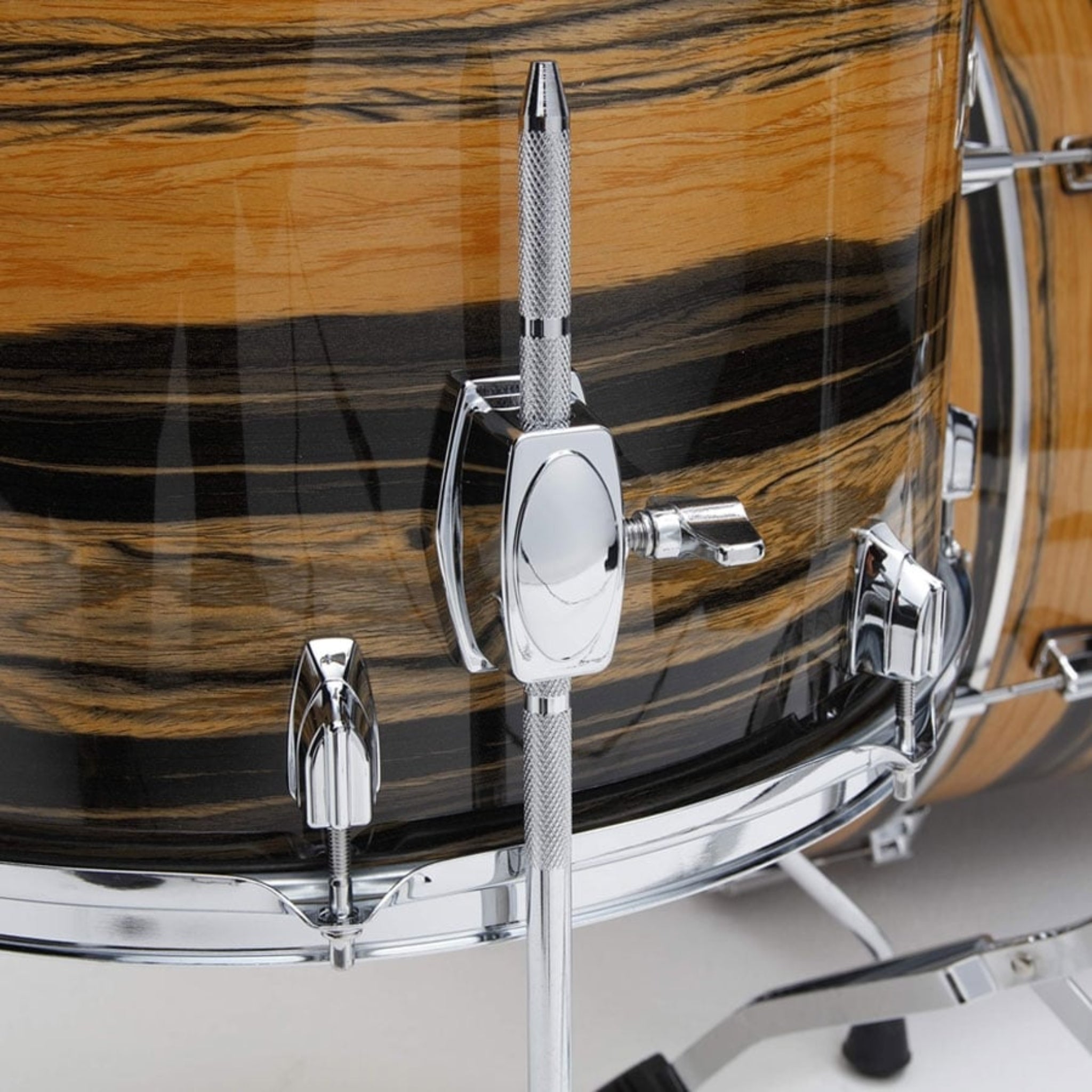 Close-up of a drum with wooden finish and chrome hardware