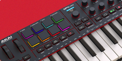 Akai MPK Mini keyboard controller on a red background