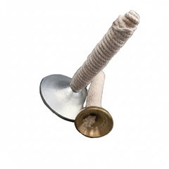 A brass and white cotton mridangam drumstick set with a circular metal base, displayed on a gray fabric background with the Zaras Bharatanatyam logo at the bottom.